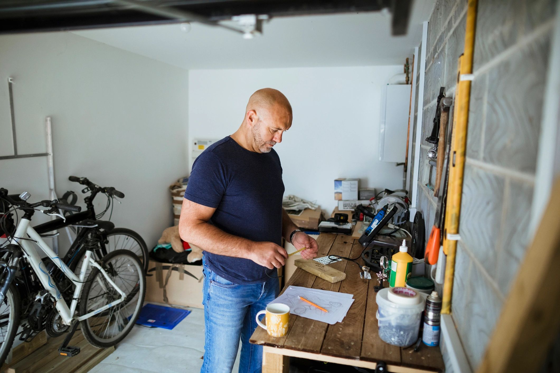 Handyman measuring wood for a home repair project